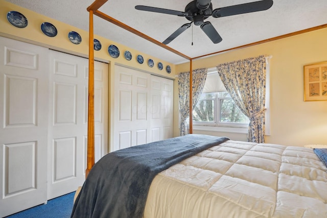 bedroom with ceiling fan, dark colored carpet, and a textured ceiling
