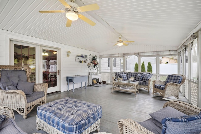 sunroom / solarium featuring a healthy amount of sunlight, wood finished floors, a ceiling fan, and lofted ceiling
