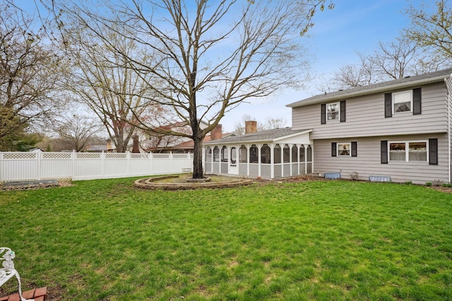 view of yard with a sunroom and fence