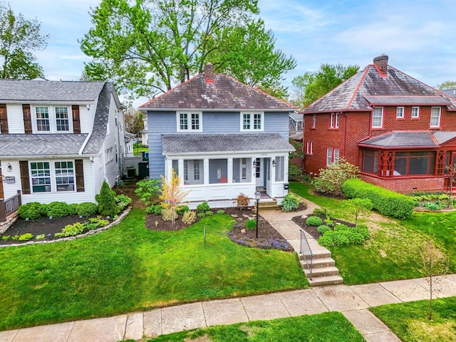 view of front of home with a front yard and a chimney