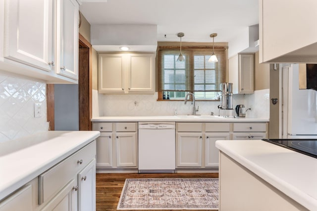 kitchen featuring a sink, dishwasher, and backsplash