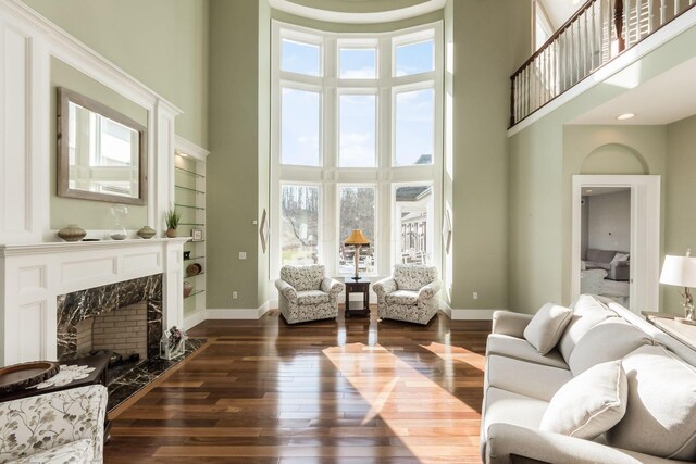 16187 Kreashbaum Rd, Rockbridge, OH 43149 - living area featuring a high ceiling, dark wood-style flooring, a premium fireplace, and plenty of natural light
