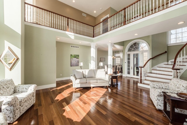 16187 Kreashbaum Rd, Rockbridge, OH 43149 - living room featuring stairway, a towering ceiling, baseboards, visible vents, and decorative columns