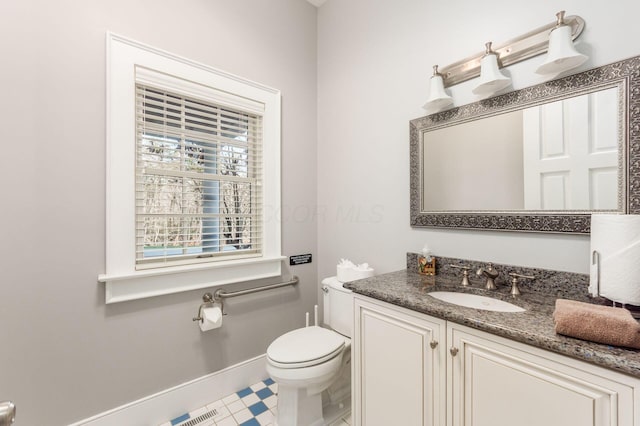 16187 Kreashbaum Rd, Rockbridge, OH 43149 - half bathroom featuring tile patterned floors, toilet, visible vents, baseboards, and vanity