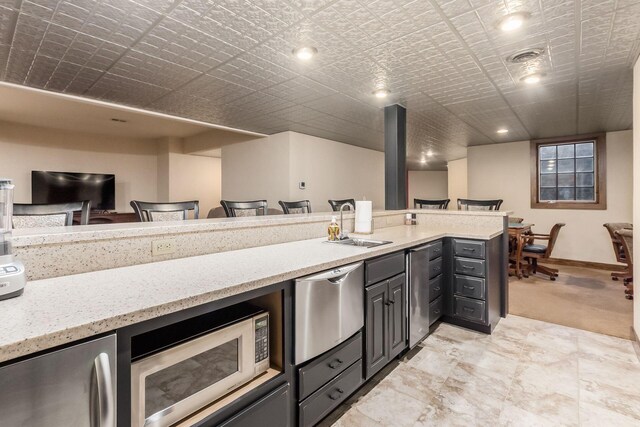 16187 Kreashbaum Rd, Rockbridge, OH 43149 - kitchen featuring a sink, stainless steel microwave, light stone countertops, fridge, and open floor plan