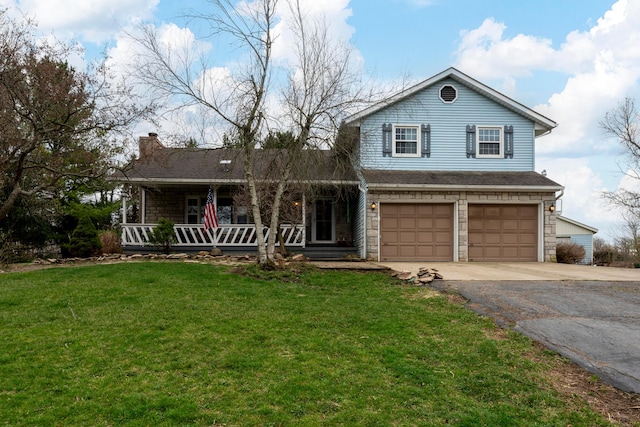 view of front facade featuring a front lawn, an attached garage, covered porch, and aphalt driveway