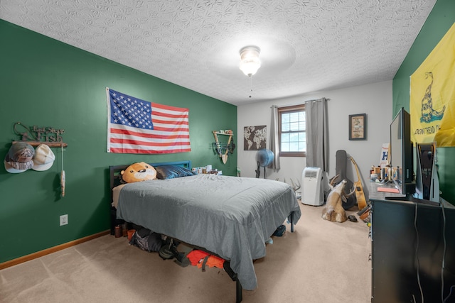carpeted bedroom with baseboards and a textured ceiling