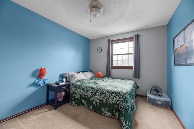 carpeted bedroom with baseboards, ceiling fan, and a textured ceiling
