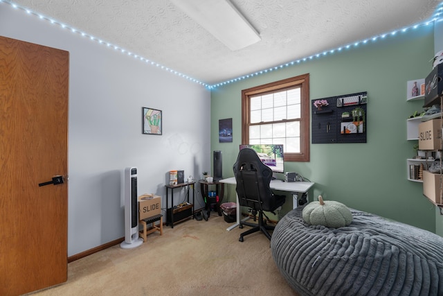 home office with a textured ceiling, baseboards, and carpet floors