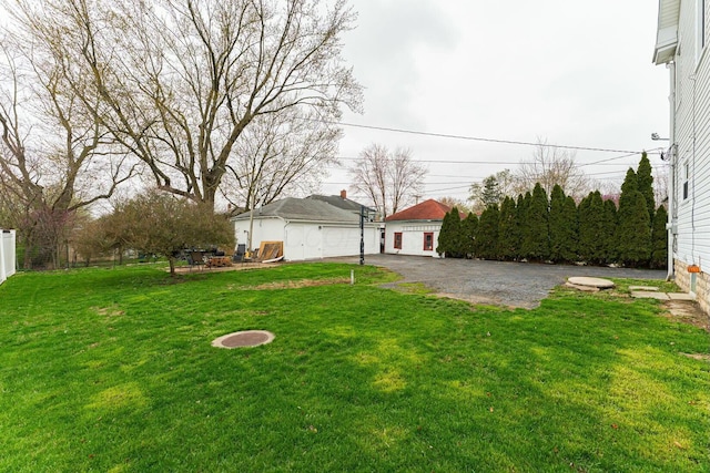 view of yard featuring a patio area, fence, and an outdoor structure