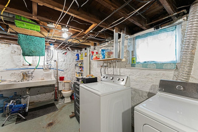 clothes washing area featuring washing machine and dryer and laundry area