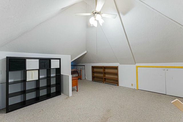 additional living space with carpet flooring, ceiling fan, and lofted ceiling