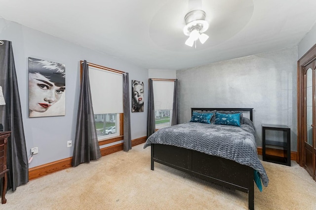 bedroom featuring light carpet, baseboards, and a ceiling fan