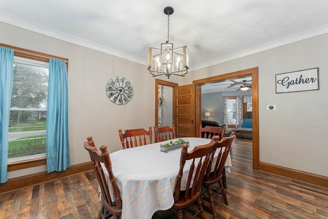 dining room featuring ceiling fan with notable chandelier, ornamental molding, baseboards, and dark wood finished floors