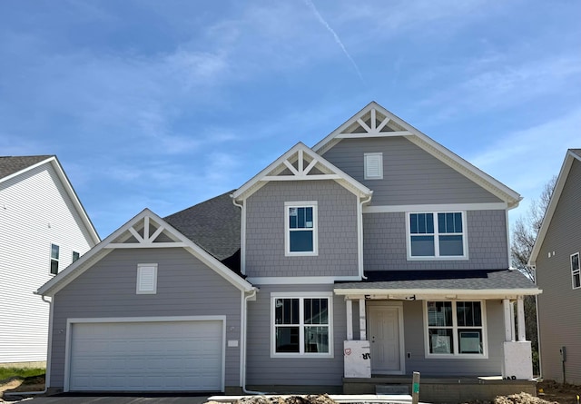 9932 Glenfield Ct Lot 50, Plain City, OH 43064 - craftsman-style house featuring a porch, asphalt driveway, roof with shingles, and an attached garage