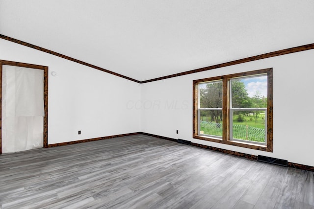 5614 US Highway 42, Mount Gilead, OH 43338 - empty room with wood finished floors, lofted ceiling, baseboards, and crown molding