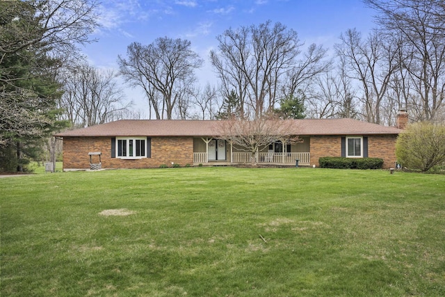 11378 Ann Dr NW, Baltimore, OH 43105 - single story home with roof with shingles, a chimney, a front lawn, brick siding, and a porch