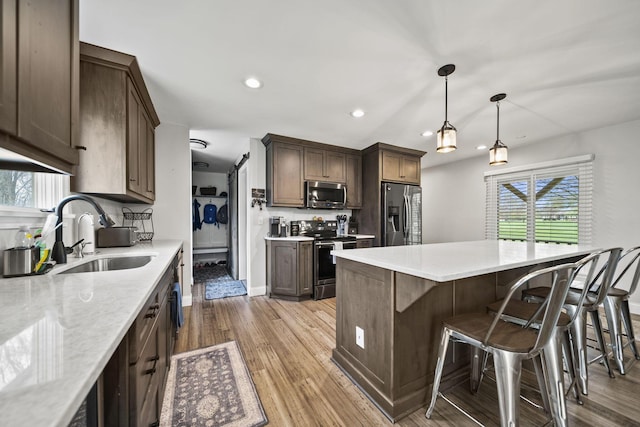 11378 Ann Dr NW, Baltimore, OH 43105 - kitchen featuring recessed lighting, plenty of natural light, appliances with stainless steel finishes, light wood finished floors, and a sink