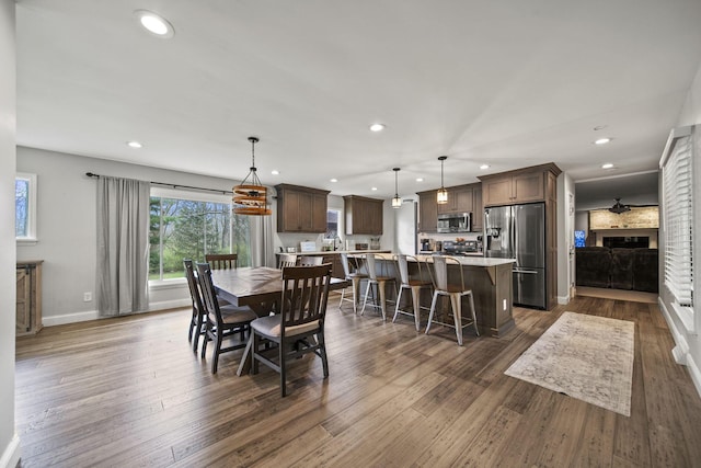 11378 Ann Dr NW, Baltimore, OH 43105 - dining space featuring a fireplace, baseboards, dark wood finished floors, and recessed lighting