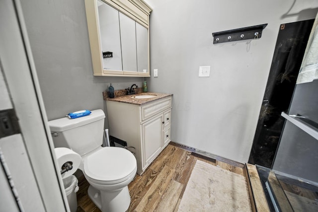 11378 Ann Dr NW, Baltimore, OH 43105 - bathroom with vanity, toilet, and wood finished floors