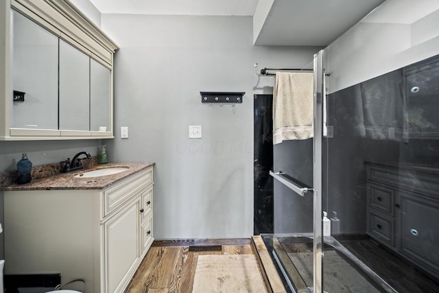 11378 Ann Dr NW, Baltimore, OH 43105 - bathroom featuring an enclosed shower, wood finished floors, and vanity