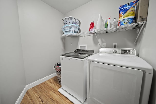 11378 Ann Dr NW, Baltimore, OH 43105 - clothes washing area with light wood-style flooring, washer and dryer, laundry area, and baseboards