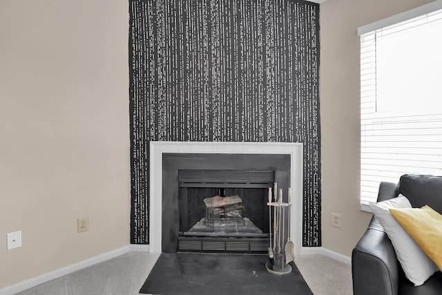 room details with a fireplace with flush hearth, carpet, and baseboards