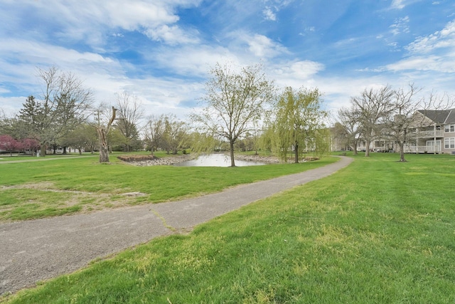 view of property's community featuring a yard and a water view