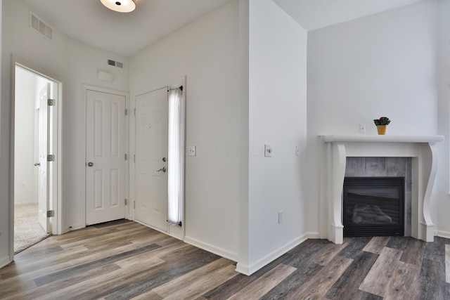 8050 Flint Run Pl, Columbus, OH 43235 - entryway with wood finished floors, a tiled fireplace, and baseboards
