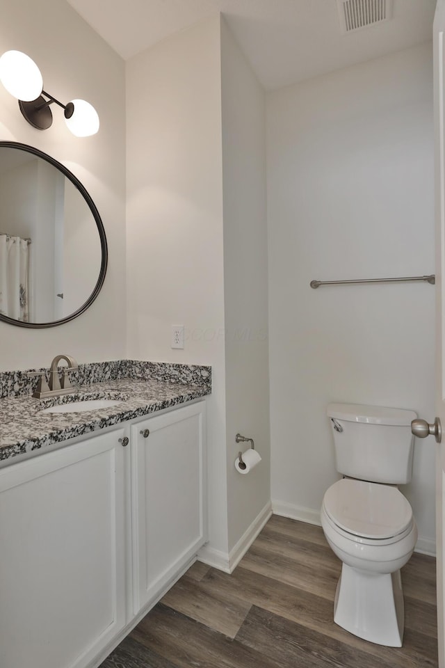 8050 Flint Run Pl, Columbus, OH 43235 - bathroom with vanity, wood finished floors, toilet, and baseboards
