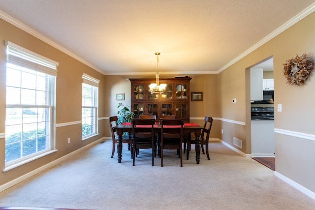 carpeted dining space with visible vents, baseboards, ornamental molding, and an inviting chandelier