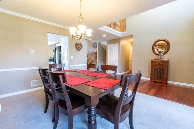 dining space featuring visible vents, ornamental molding, baseboards, stairs, and a notable chandelier