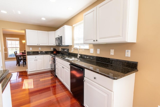kitchen with a sink, dark wood finished floors, recessed lighting, white cabinetry, and black appliances
