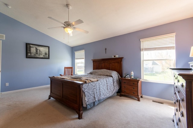 bedroom with vaulted ceiling, carpet flooring, visible vents, and baseboards
