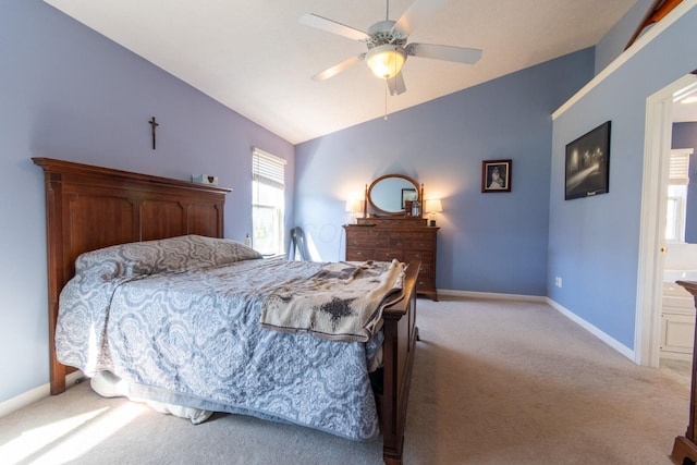 bedroom featuring lofted ceiling, a ceiling fan, carpet floors, baseboards, and ensuite bathroom