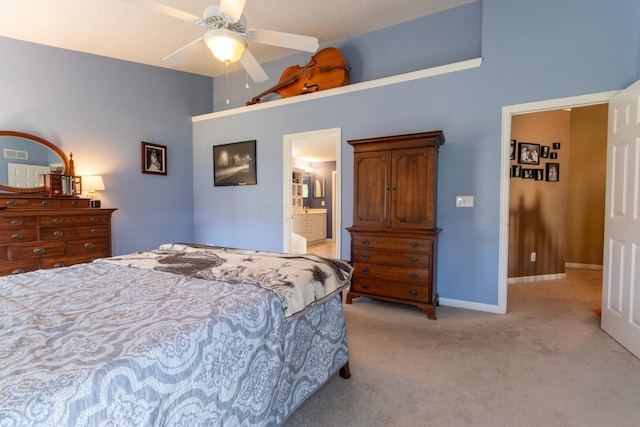 bedroom featuring ceiling fan, light carpet, ensuite bathroom, and baseboards