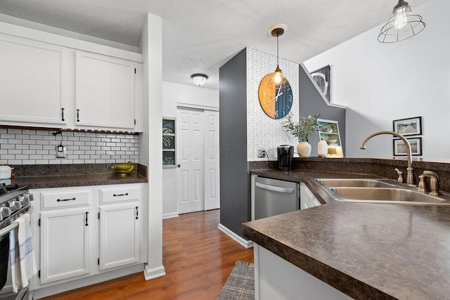 3379 Fishinger Mill Dr, Hilliard, OH 43026 - kitchen with a sink, dark countertops, appliances with stainless steel finishes, white cabinetry, and a textured ceiling