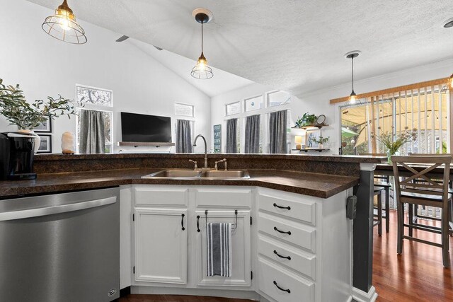 3379 Fishinger Mill Dr, Hilliard, OH 43026 - kitchen with dishwasher, a sink, dark countertops, vaulted ceiling, and white cabinets