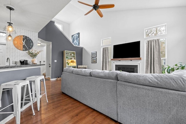 3379 Fishinger Mill Dr, Hilliard, OH 43026 - living area with high vaulted ceiling, ceiling fan, wood finished floors, a fireplace, and baseboards
