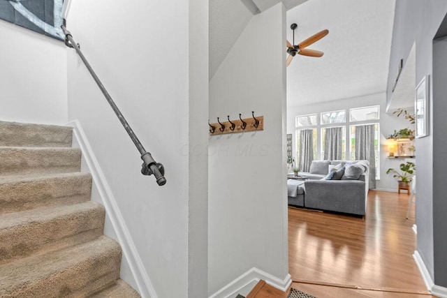3379 Fishinger Mill Dr, Hilliard, OH 43026 - stairway featuring wood finished floors, baseboards, ceiling fan, and vaulted ceiling