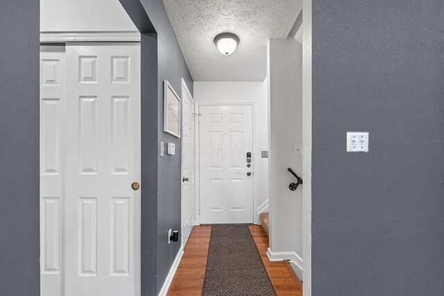 3379 Fishinger Mill Dr, Hilliard, OH 43026 - corridor featuring wood finished floors, a textured ceiling, and baseboards