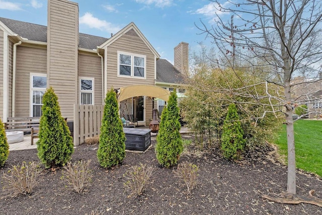 3379 Fishinger Mill Dr, Hilliard, OH 43026 - back of house with a chimney and roof with shingles
