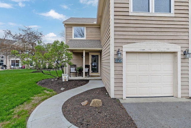 3379 Fishinger Mill Dr, Hilliard, OH 43026 - property entrance featuring a lawn, a shingled roof, a garage, and covered porch