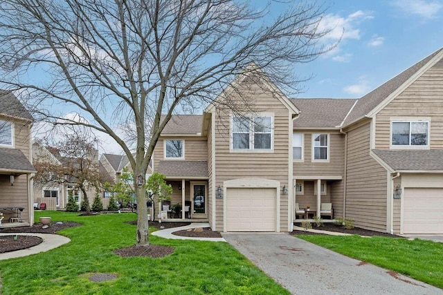 3379 Fishinger Mill Dr, Hilliard, OH 43026 - townhome / multi-family property featuring asphalt driveway, a front yard, and an attached garage