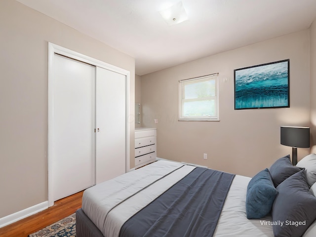 bedroom featuring light wood finished floors and a closet