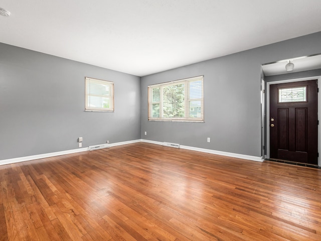 foyer entrance featuring wood finished floors and baseboards