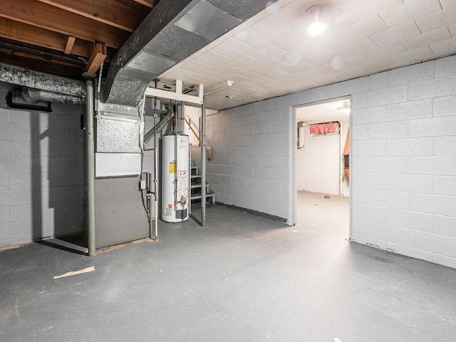 unfinished below grade area with gas water heater and concrete block wall