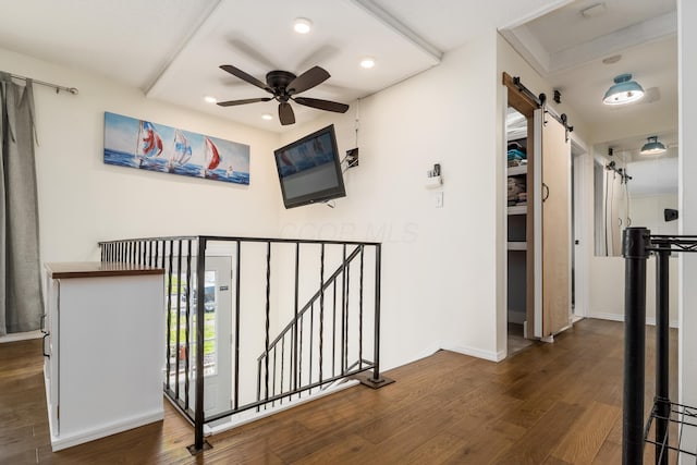 1706 Kinross Ln, Galloway, OH 43119 - hallway featuring a barn door, recessed lighting, wood finished floors, an upstairs landing, and baseboards