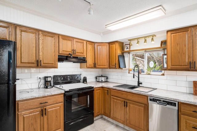 1706 Kinross Ln, Galloway, OH 43119 - kitchen with brown cabinets, under cabinet range hood, backsplash, a sink, and black appliances