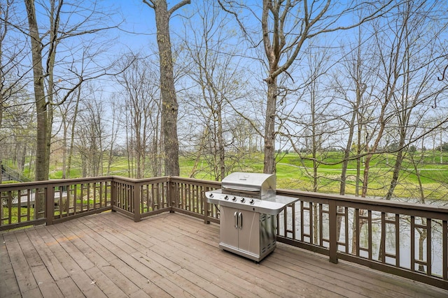 wooden deck featuring a grill